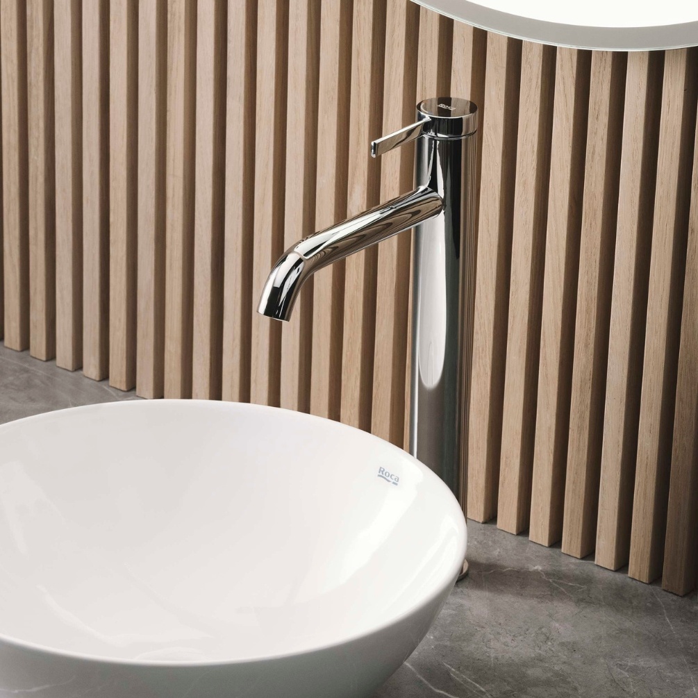 Lifestyle image of the Roca Ona Chrome Tall Basin Mixer Tap installed next to a countertop basin